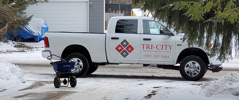 Our truck parked next to a salt wagon on a snoyw day in Midland, MI.