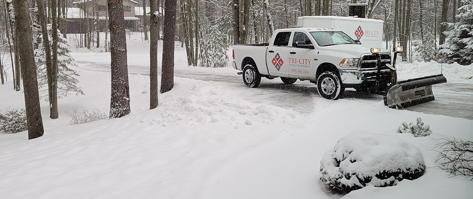 Our truck equip with a snow plow on a snowy day in the Midland, MI area. 