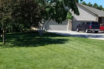 Midland home with a professionally mowed and maintained lawn.