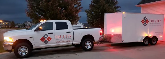 Tri-City Property Maintenance truck and trailer.